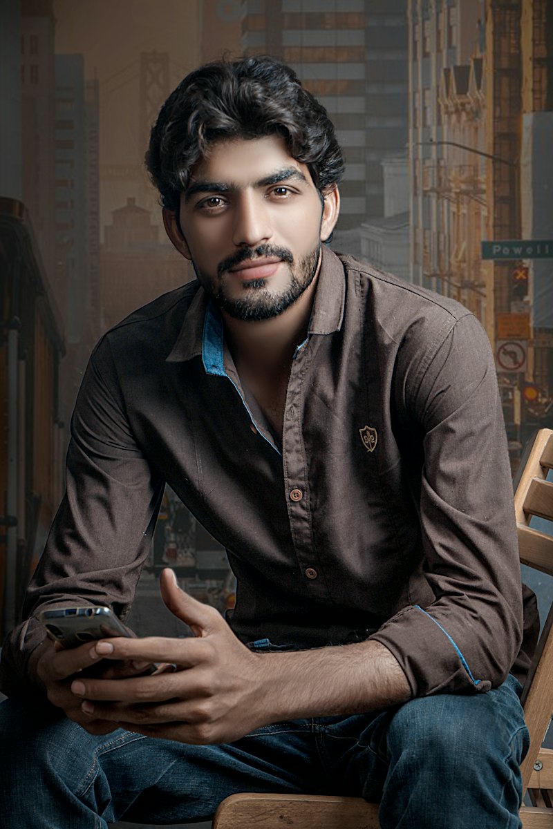 A young man sitting with his phone